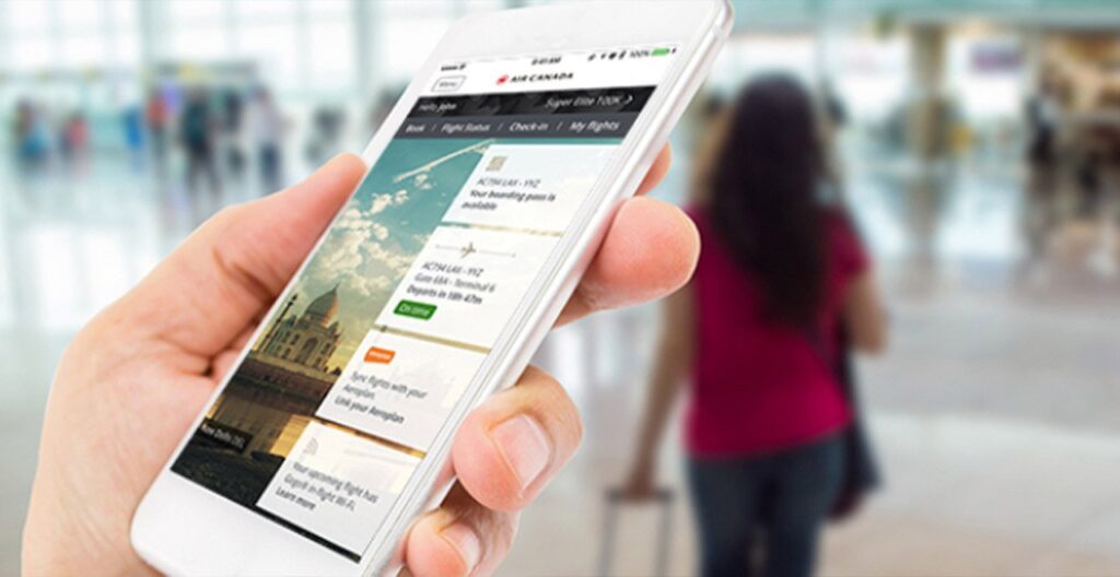 Person holding smart phone with Air Canada mobile app on screen