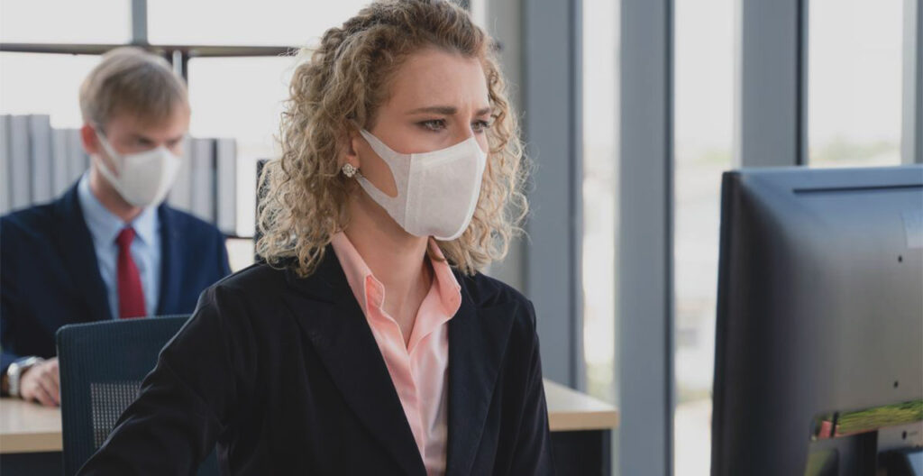 Office workers wearing masks - COVID
